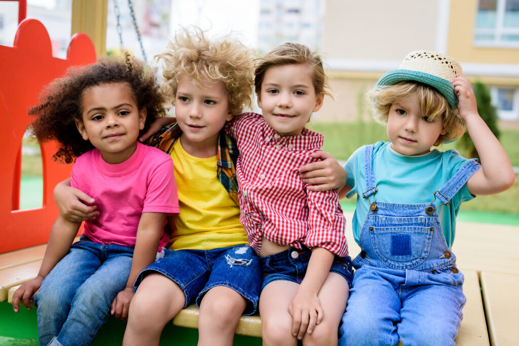 Diverse group of children sitting together, representing cognitive development in children through different stages.