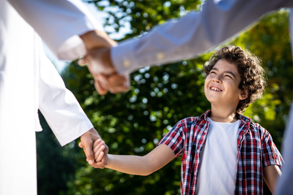 Emirati family connecting and fostering emotional intelligence through supportive relationships and outdoor activities.